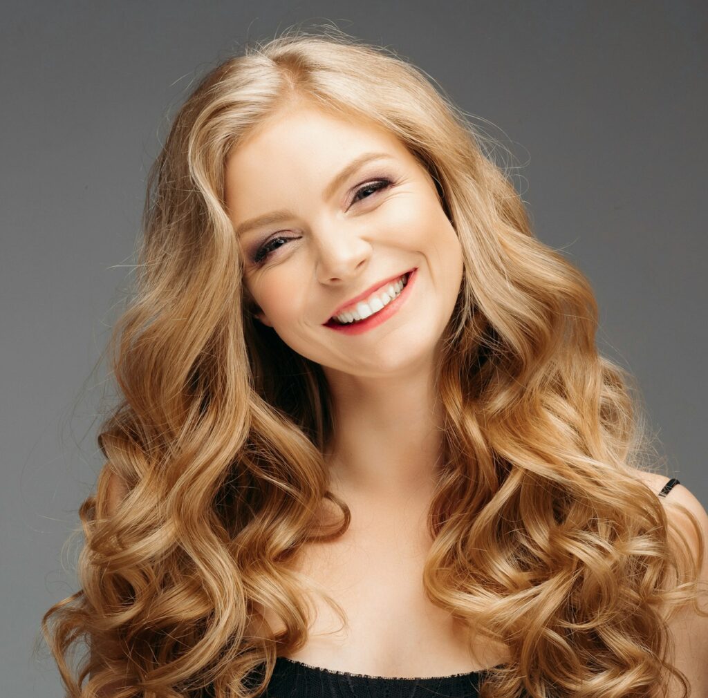 Stunning natural beauty with blonde wavy hair.